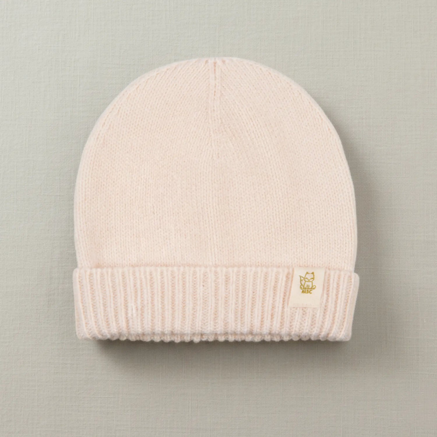 Ecru kleurige merinwolllen babymuts 