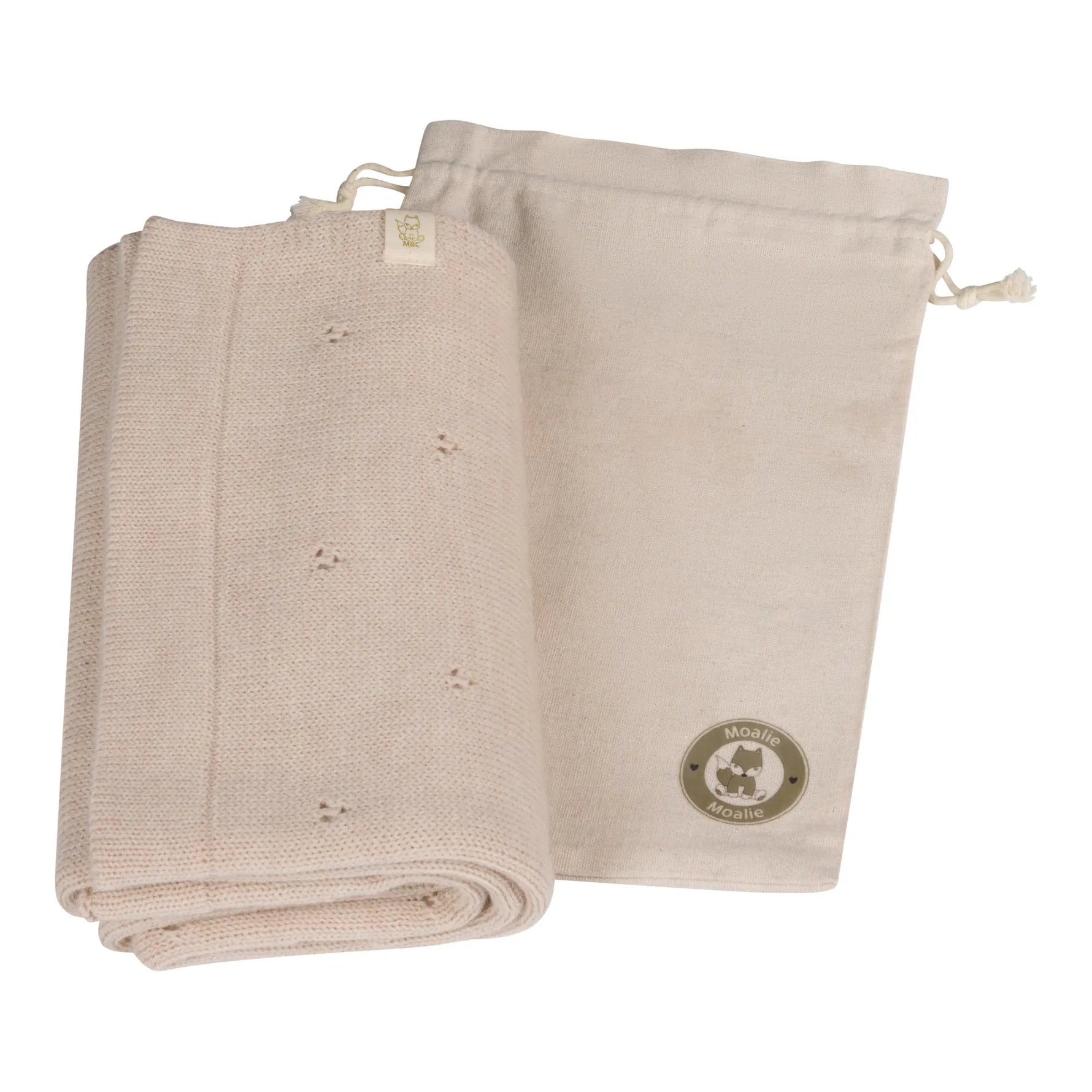 opgevouwen beige wollen pointelle deken met opbergzak 