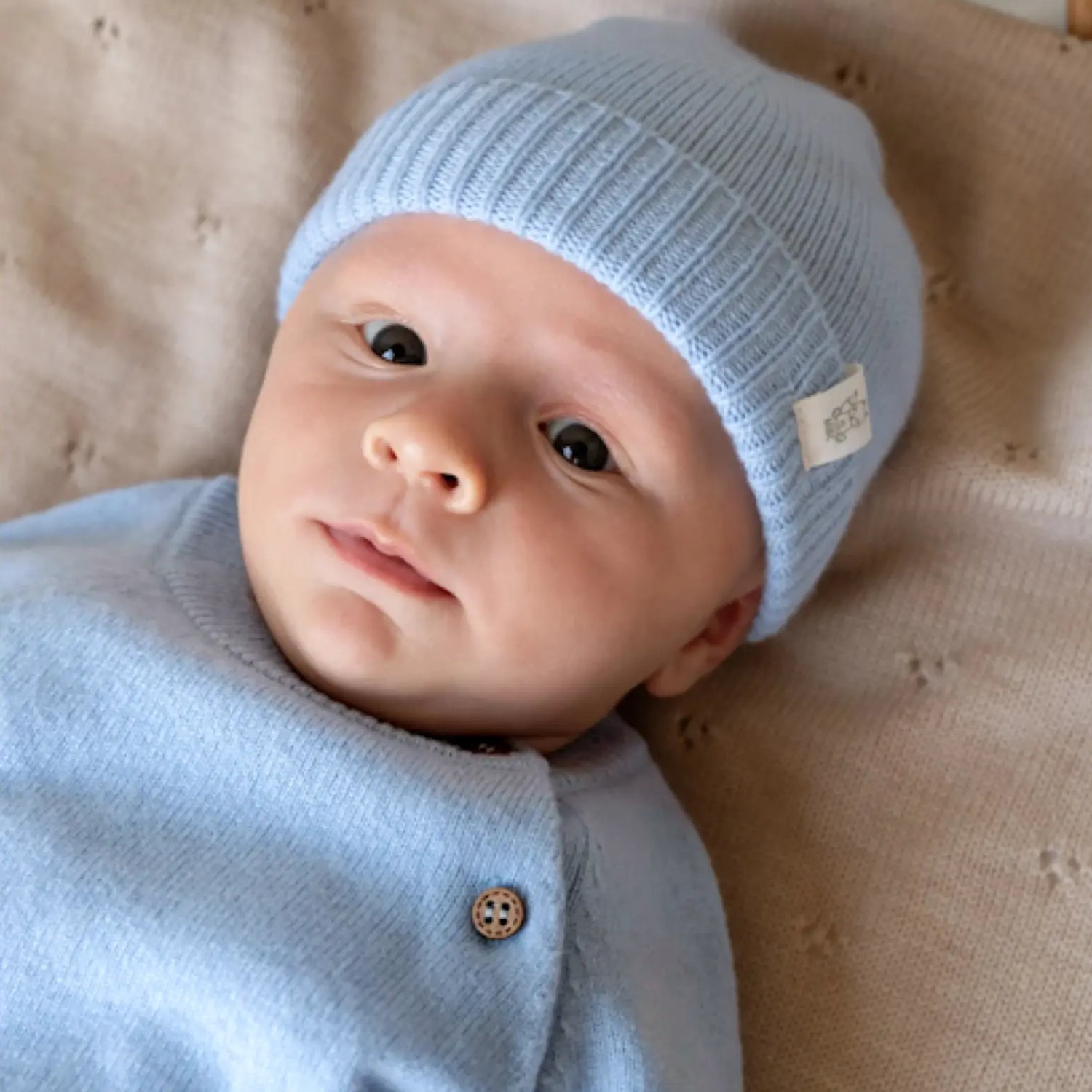 baby in merino wool and cashmere beanie and pullover in light blue