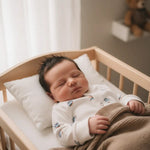 slapende baby in boxpakje met vliegtuig print 